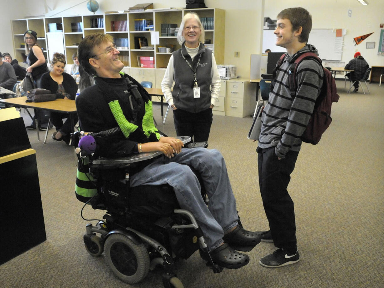 Motivational speaker Ron Heagy Jr. of Millersburg, Ore., left, talks with Warren Scott Brown, 17, and teacher Deanna Kozak after speaking to students at Albany Options School in Albany, Ore.