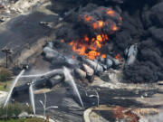 Black smoke billows from burning tanker cars on July 6, 2013, in Lac-Megantic, Quebec.