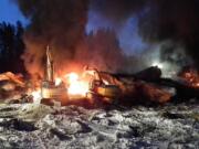 Transportation Safety Board of Canada files
Workers fight a fire Feb. 16 after a crude oil train derailment south of south of Timmins, Ontario. The train derailment this month suggests new safety requirements for tank cars carrying flammable liquids are inadequate, Canada's transportation safety board announced Monday.