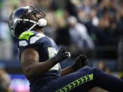 Seattle Seahawks defensive end Cliff Avril reacts after he sacked Arizona Cardinals quarterback Drew Stanton in the first half of an NFL football game, Sunday, Nov. 23, 2014, in Seattle.