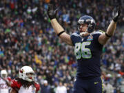 Seattle Seahawks tight end Zach Miller (86) celebrates in front of Arizona Cardinals strong safety Rashad Johnson (49) after scoring on a 24-yard touchdown reception during the second quarter Sunday.