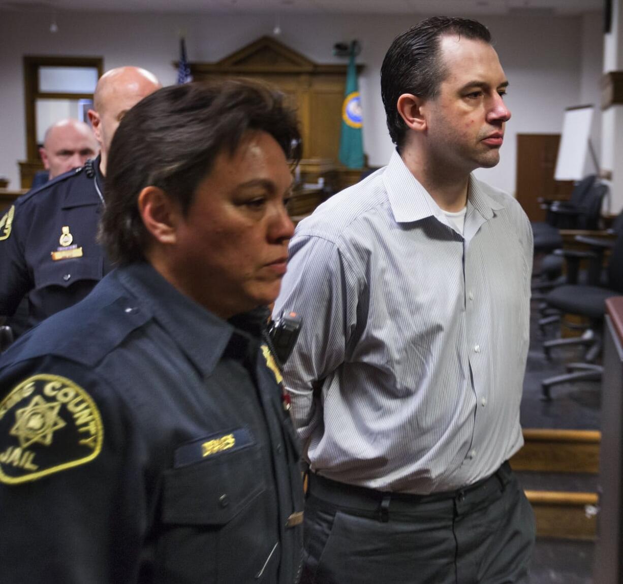 Joseph McEnroe is led out of the courtroom on Wednesday in Seattle after being found guilty of murdering a family of six on Christmas Eve in 2007.