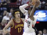 Portland Trail Blazers forward LaMarcus Aldridge, right, looks to pass as Cleveland Cavaliers center Anderson Varejao, from Brazil, defends during the first half of an NBA basketball game in Portland, Ore., Tuesday, Nov.