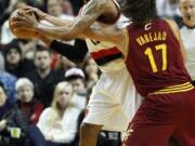 Portland Trail Blazers' LaMarcus Aldridge works against Cleveland's Anderson Varejao.