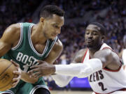 Boston Celtics guard Evan Turner, left, looks to maneuver against Portland Trail Blazers guard Wesley Matthews during the second half Thursday, Jan. 22, 2015. Turner scored 10 points, including the game-winning 3-pointer, in the Celtics' 90-89 victory.