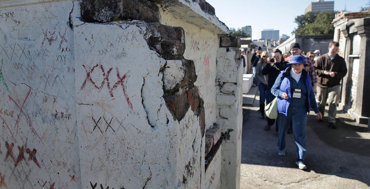 A tour group led by Jill Kaplan works its way through the tombs, stories, myths and legends of St. Louis Cemetery No. 1, Jan. 26 in New Orleans.