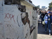 A tour group led by Jill Kaplan works its way through the tombs, stories, myths and legends of St. Louis Cemetery No. 1, Jan. 26 in New Orleans.