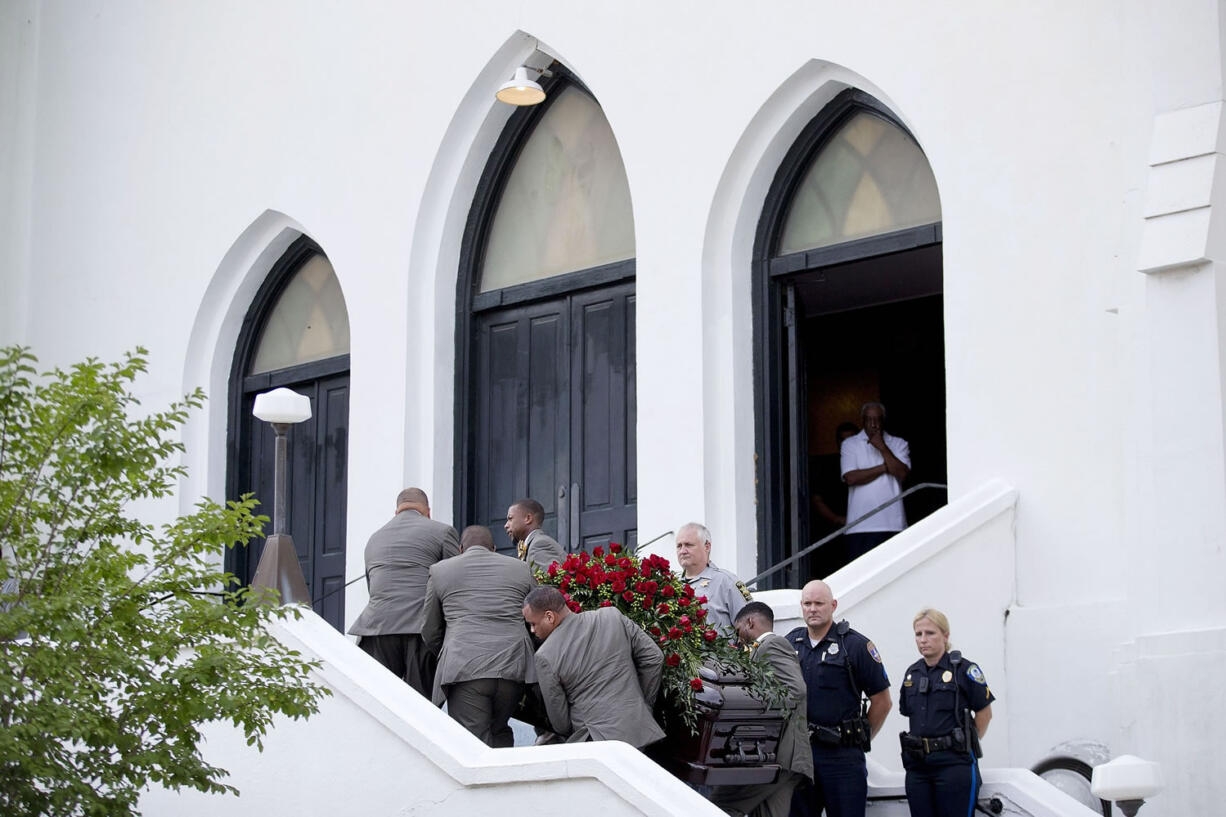 Pallbearers carry the casket of Sen.