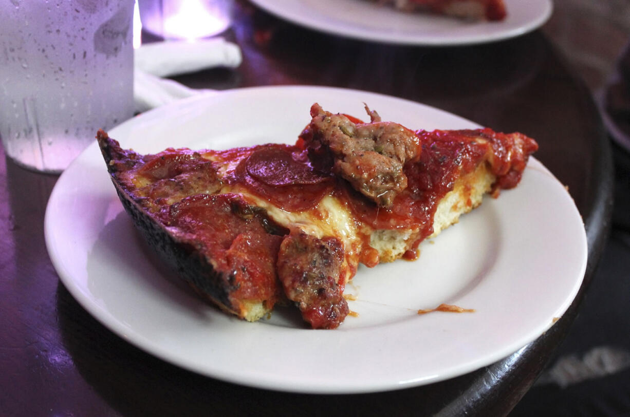 In this Sept. 5, 20143 photo, a slice of deep-dish pizza is shown at Pequod's in Chicago. Chicago is one of a handful of cities across the country, like Boston, Milwaukee and New York, with companies that offer tours of the local pizza scene.