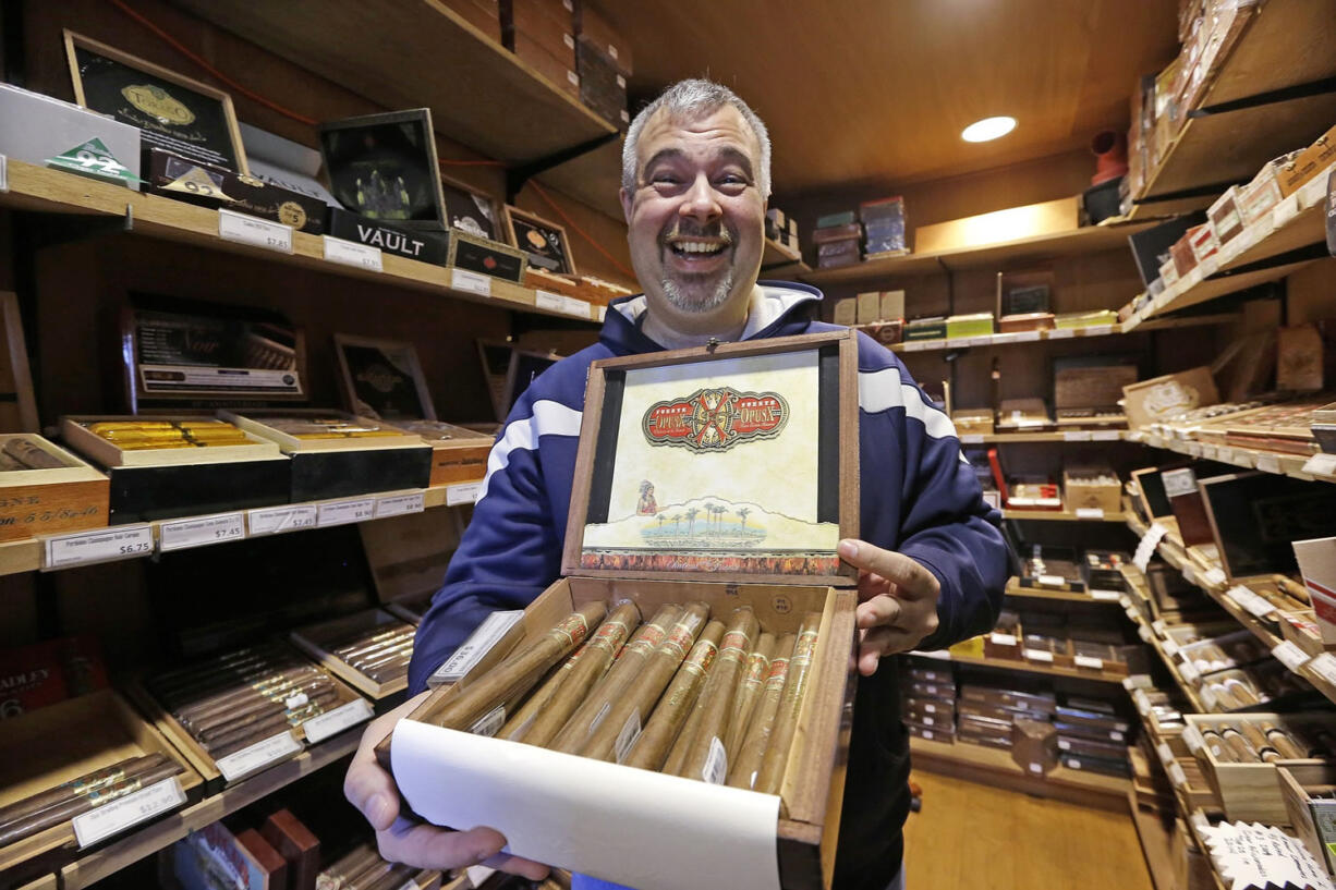 F.K. Kirsten manager Paul Durocher displays a box of cigars Monday in a room-sized humidor at the store in Seattle. In the years since Washington voters approved a statewide smoking ban nearly a decade ago, cigar smokers are thin on options for places to light up and smoke.