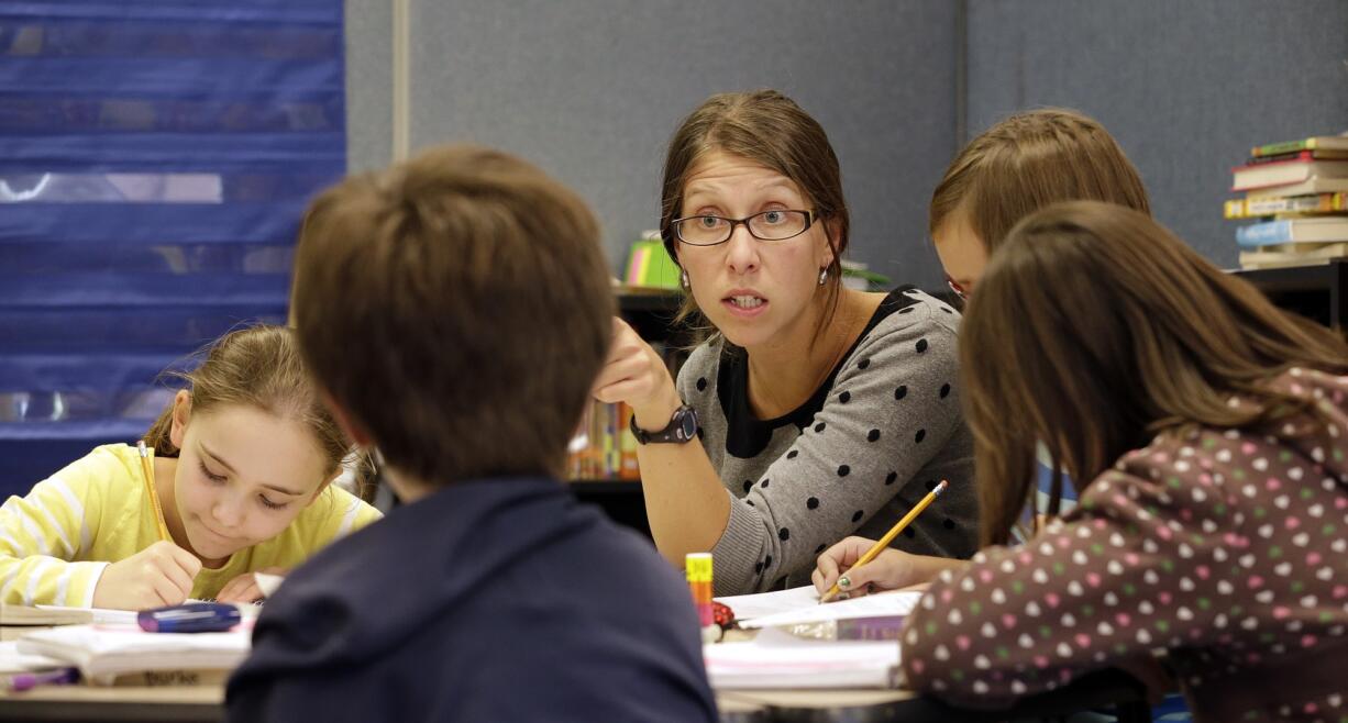 Teacher Joy Burke works Thursday with her fifth grade students at John Hay Elementary school in Seattle.