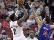 Portland Trail Blazers guard Wesley Matthews, left, shoots over Los Angeles Clippers guard J.J. Redick during the first half of Sunday's preseason game in Portland, Ore., Sunday, Oct.