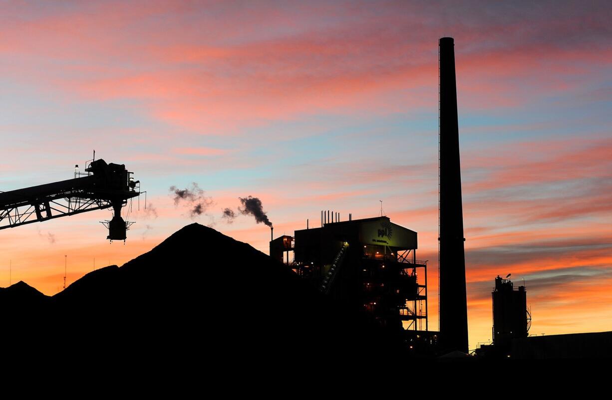 Sunrise colors the sky Jan. 27 over PPL Montana's Corette power plant in Billings, Mont. The power plant will shut down in August, owner PPL Montana said Tuesday, marking the latest in a wave of closures across the country that have left the coal industry reeling.