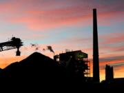 Sunrise colors the sky Jan. 27 over PPL Montana's Corette power plant in Billings, Mont. The power plant will shut down in August, owner PPL Montana said Tuesday, marking the latest in a wave of closures across the country that have left the coal industry reeling.