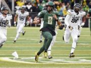 Oregon quarterback Marcus Mariota (8) runs for a touchdown during the first quarter against the Colorado on Saturday, Nov. 22, 2014, in Eugene, Ore.