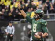 Oregon quarterback Marcus Mariota (8) celebrates after scoring a touchdown during the first quarter of an NCAA college football game against the Colorado on Saturday, Nov. 22, 2014, in Eugene, Ore.