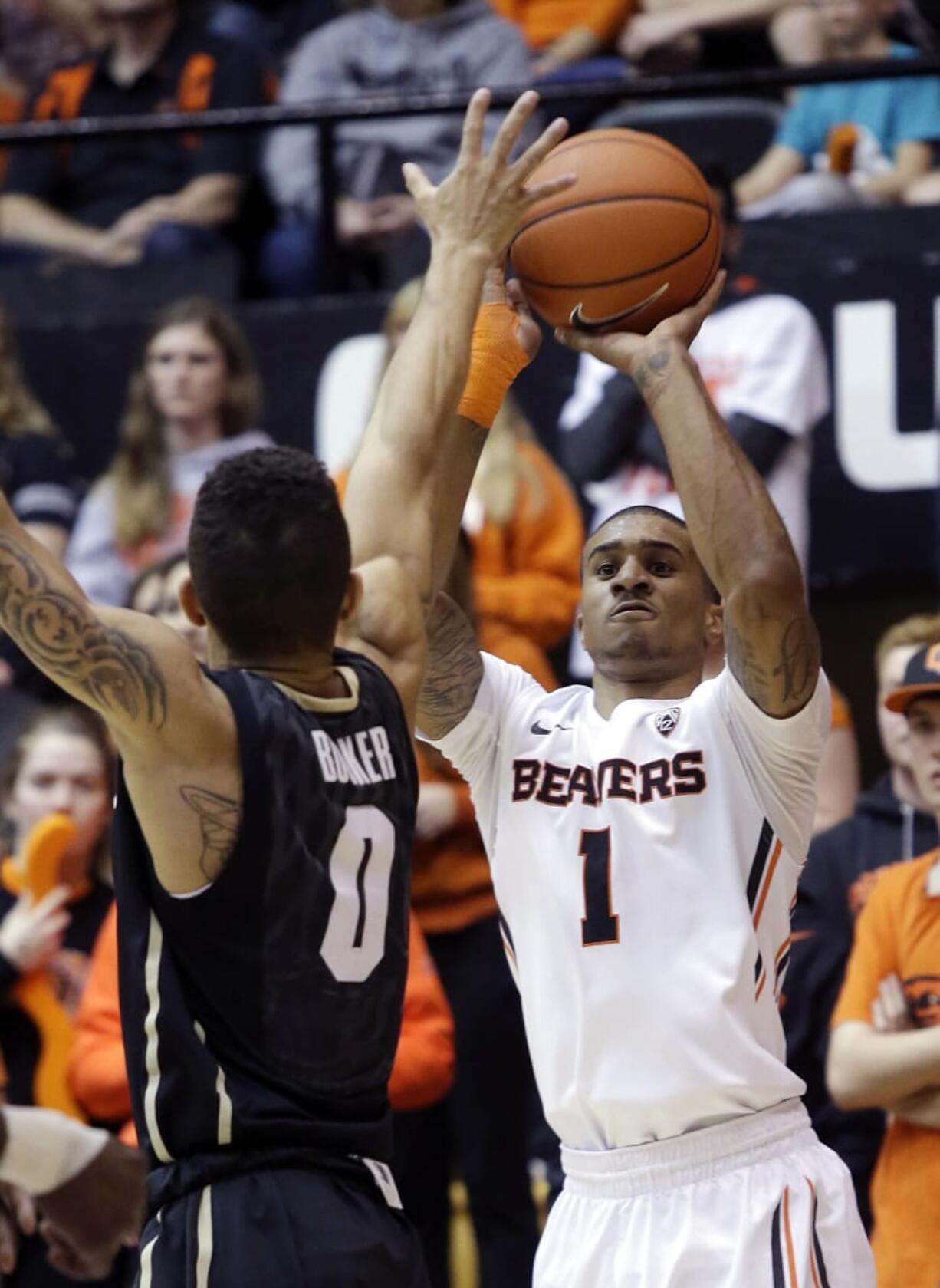 Oregon State guard Gary Payton II shoots against Colorado guard Askia Booker during the second half in Corvallis, Ore., Saturday, Feb. 21, 2015.