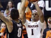 Oregon State guard Gary Payton II shoots against Colorado guard Askia Booker during the second half in Corvallis, Ore., Saturday, Feb. 21, 2015.