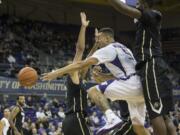 Washington's Nigel Williams-Goss, center, passes in traffic as Colorado's Xavier Talton, left, and Wesley Gordon defend during the first half Thursday, March 5, 2015, in Seattle.