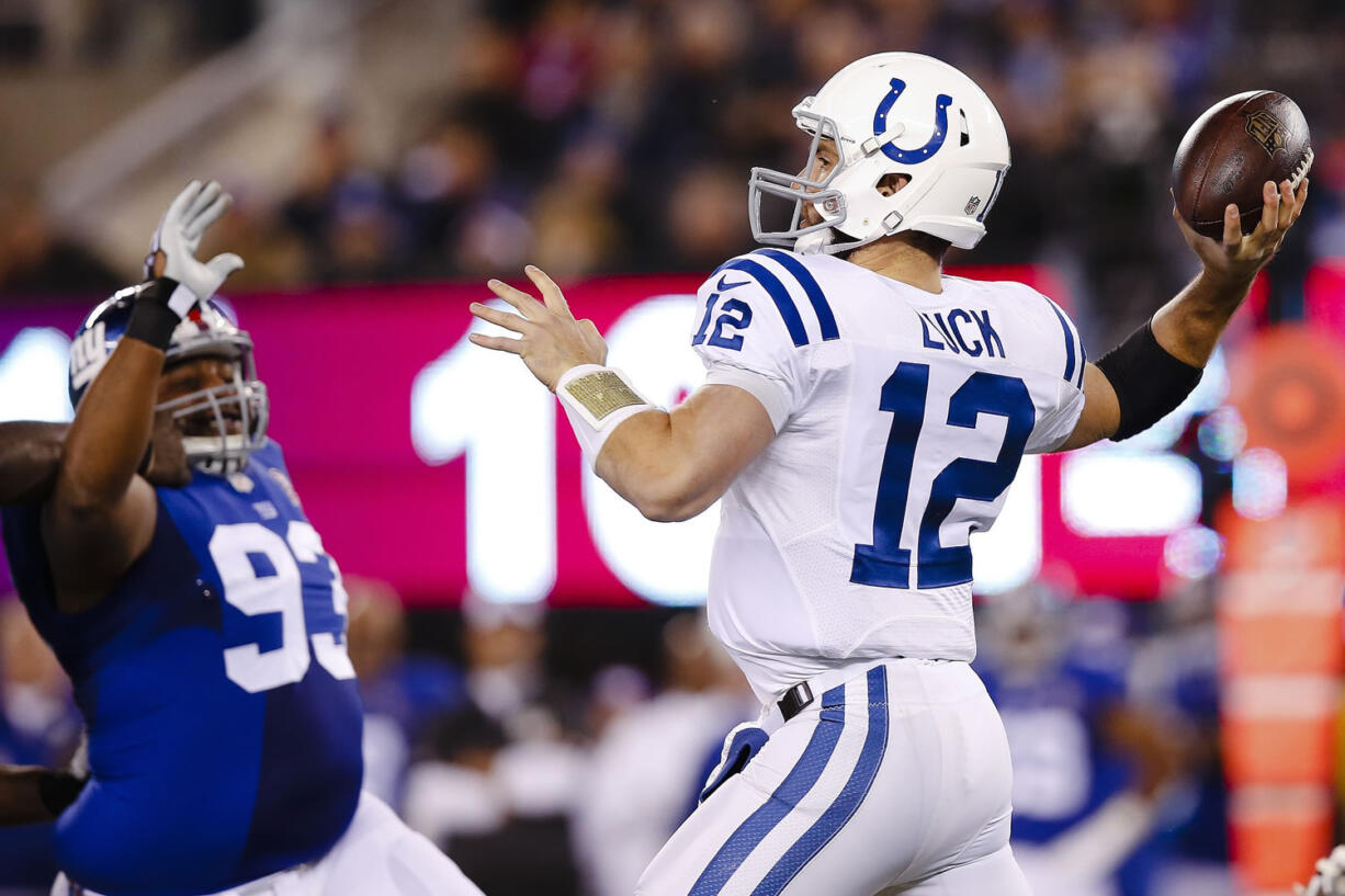 Indianapolis Colts quarterback Andrew Luck (12) throws a pass as New York Giants defensive tackle Mike Patterson (93) rushes him during the first half Monday, Nov. 3, 2014, in East Rutherford, N.J.