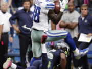 Dallas receiver Dez Bryant (88) had three catches for 52 yards while being covered by Richard Sherman, bottom.