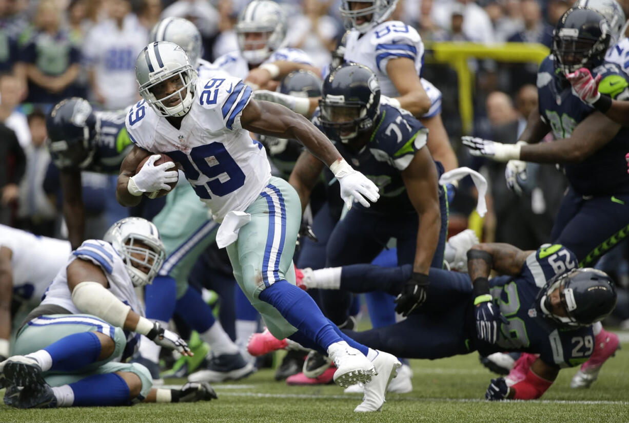 Dallas Cowboys running back DeMarco Murray (29) runs for a touchdown in the fourth quarter against the Seattle Seahawks, Sunday, Oct. 12, 2014, in Seattle.