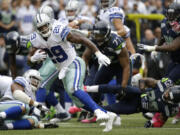 Dallas Cowboys running back DeMarco Murray (29) runs for a touchdown in the fourth quarter against the Seattle Seahawks, Sunday, Oct. 12, 2014, in Seattle.