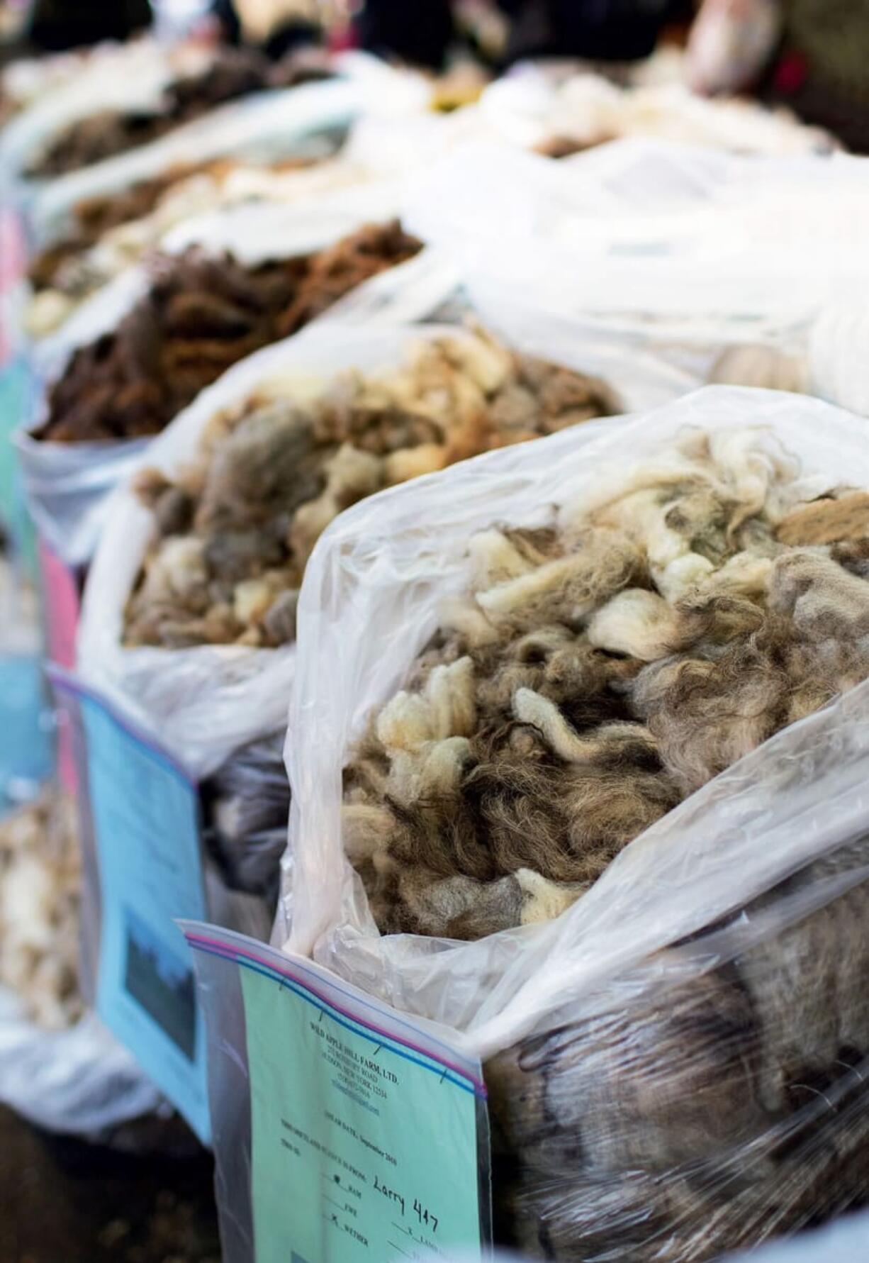 Photos from Storey Publishing
Raw fleece, from left, is for sale at the New York Sheep and Wool Festival. A basket of colorful fiber is part of a spinner's stash. After the knitting and crochet revivals comes a hand-spinning resurgence as those who work with yarn seek more versatility and control over their projects.