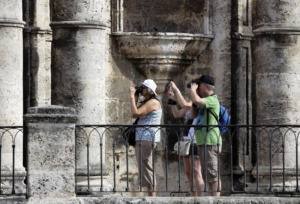 Tourists shoot pictures outside the Cathedral in Old Havana, Cuba.