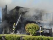 Firefighters douse two house fires in Vancouver's Old Evergreen Highway neighborhood on Wednesday evening.