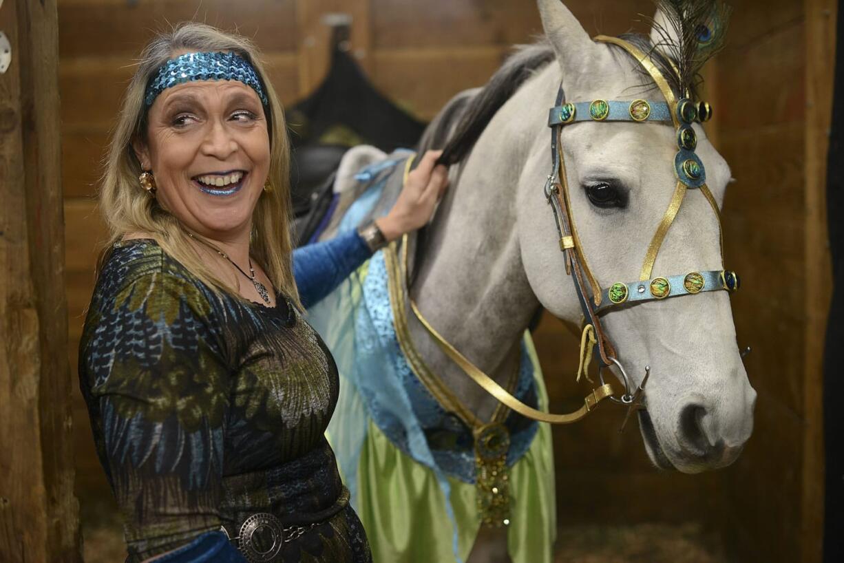 Lisa Badger decorates her Lipizon mare, Columbia, in peacock themed accessories in preparation for the Washington State Horse Expo on February 21, 2015 at the Clark County Fairgrounds.