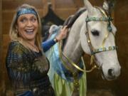 Lisa Badger decorates her Lipizon mare, Columbia, in peacock themed accessories in preparation for the Washington State Horse Expo on February 21, 2015 at the Clark County Fairgrounds.