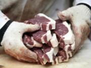 Amend Packing Company owner Kent Weise holds freshly cut New York strip steaks in Des Moines, Iowa.