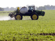 Blake Beckett of West Central Cooperative sprays a soybean field in Granger, Iowa.