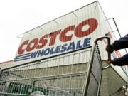 A shopper pushes a cart outside a Costco Wholesale store.