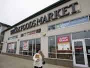 A woman walks out of the Whole Foods Market in Woodmere Village, Ohio.