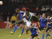 San Jose Earthquakes' Jason Hernandez defends against a shot by Portland Timbers' Rodney Wallace (22) during the first half of an MLS Soccer game in Portland, Ore., Wednesday Oct. 8, 2014.