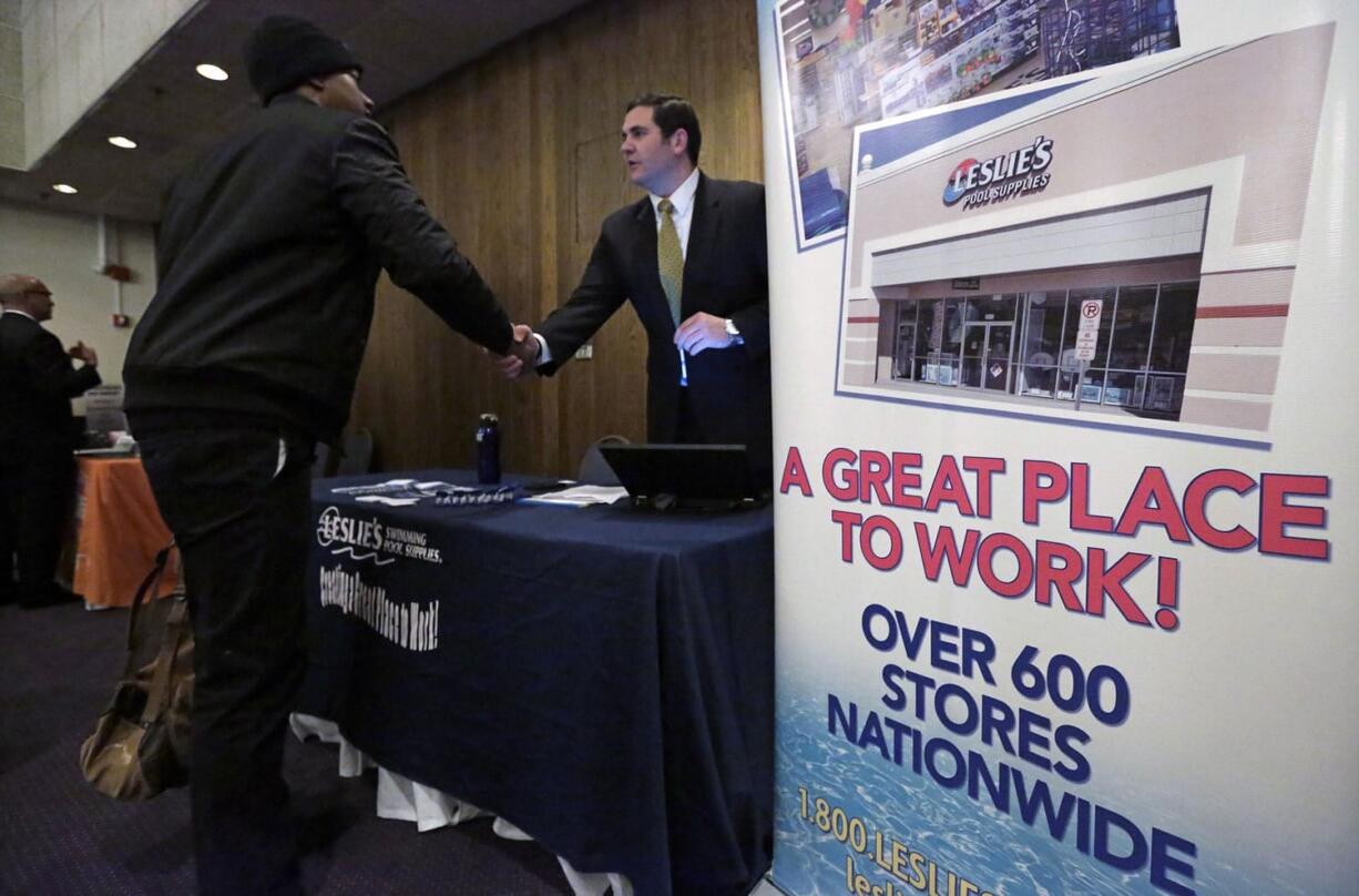 A sign at a recruiting station for Leslie's Pool supplies boasts that it is a great place to work during a National Career Fairs job fair April 22 in Chicago. The Labor Department reported Friday that the U.S. economy added 223,000 jobs in April. (AP Photo/M.