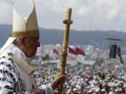 Pope Francis walks with his pastoral staff to celebrate Mass at Bicentennial Park in Quito, Ecuador, on Tuesday.