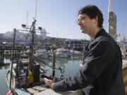 Detour co-founder and CEO Andrew Mason uses his new Detour app to take an audio tour of Fisherman's Wharf in San Francisco. Nearly two years after being fired as Groupon's CEO, Mason is setting out on a new entrepreneurial journey selling unconventional audio tours of major cities on a new iPhone app called Detour.