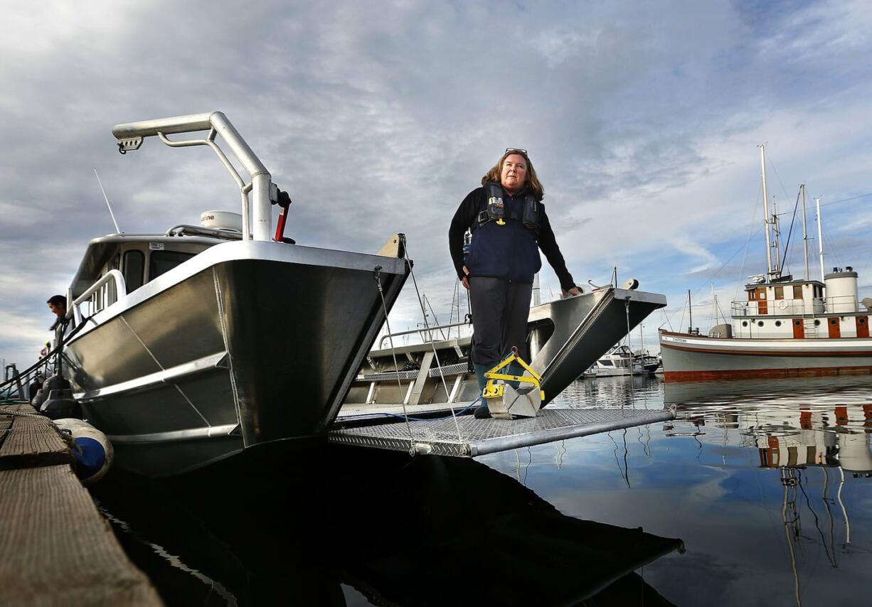 Ardi Kveven stands Wednesday on the 36-foot-long custom-built research vessel in Everett. Kveven worked on a $218,000 grant from the National Science Foundation to purchase the vessel  for Everett Community College's Ocean Research College Academy. The Phocoena will be officially christened in a ceremony Saturday on the Everett waterfront.