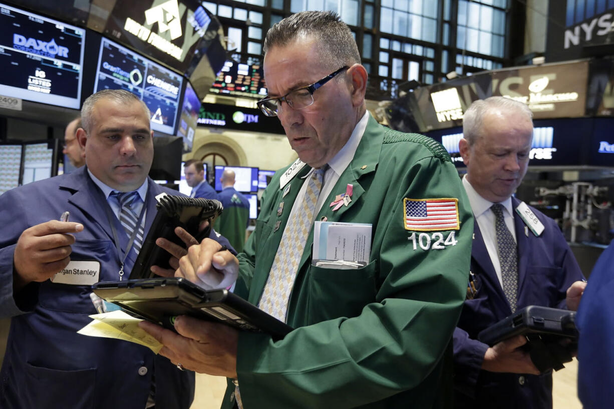 John Yaccarine, center, works with fellow traders on the floor of the New York Stock Exchange on Thursday.