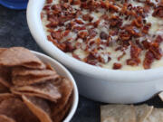 The New England super seven dip made with barbecued pulled pork topped with skillet sauteed apples and butter