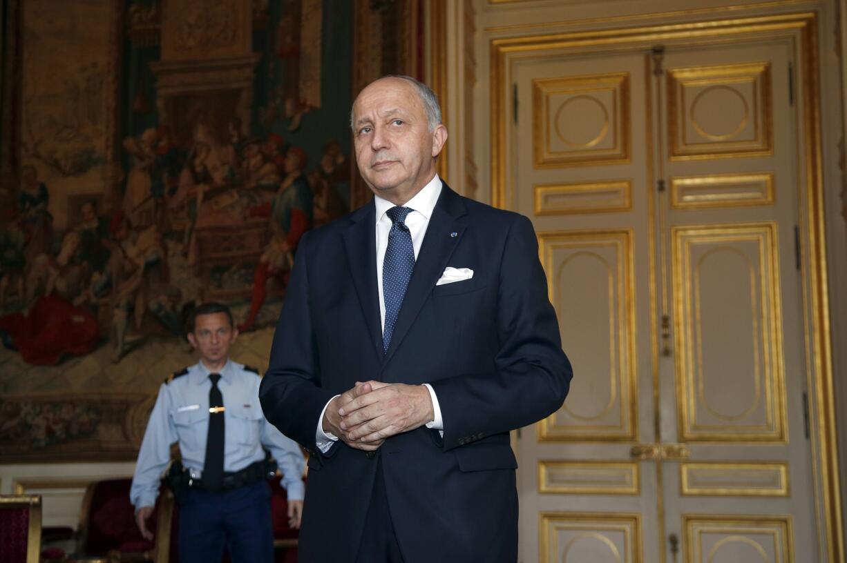 French Foreign Affairs Minister Laurent Fabius arrives to talk to the media after his meting with U.S. Ambassador Jane Hartley at Quai d'Orsay Foreign Affairs ministry in Paris Wednesday June 24, 2015.