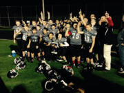 Clark County Youth Football's Titans celebrate their victory in the Majors (seventh grade) championship game Saturday at District Stadium in Battle Ground.