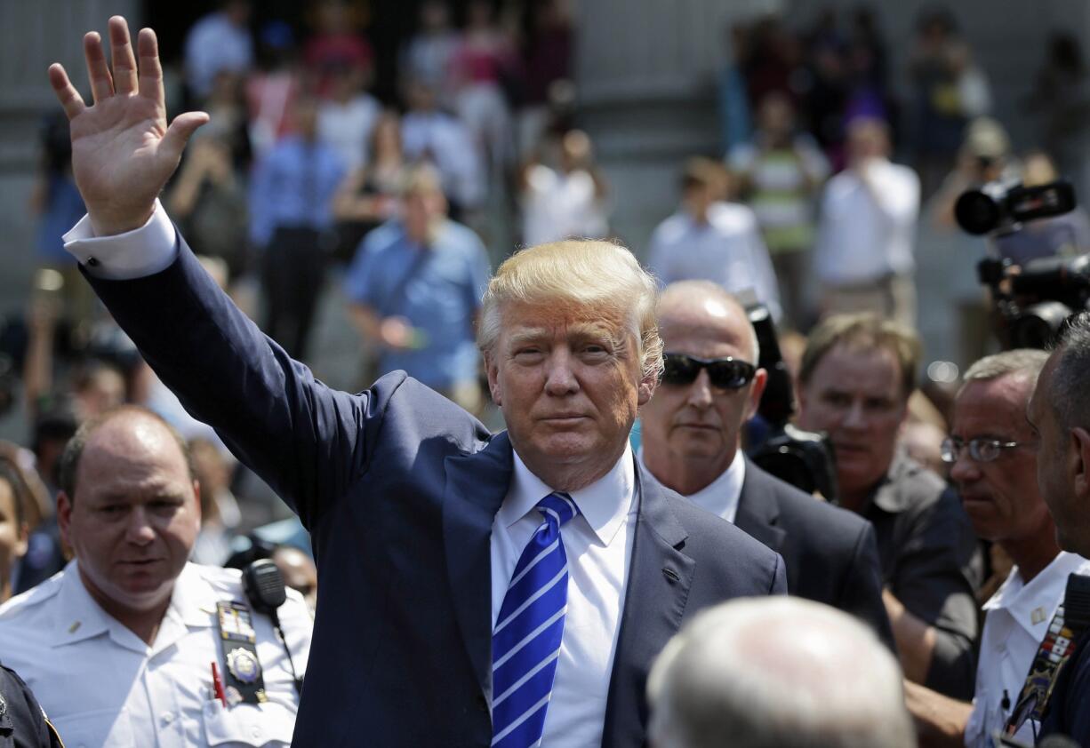 Donald Trump waves as he leaves for lunch after being summoned for jury duty in New York on Monday.