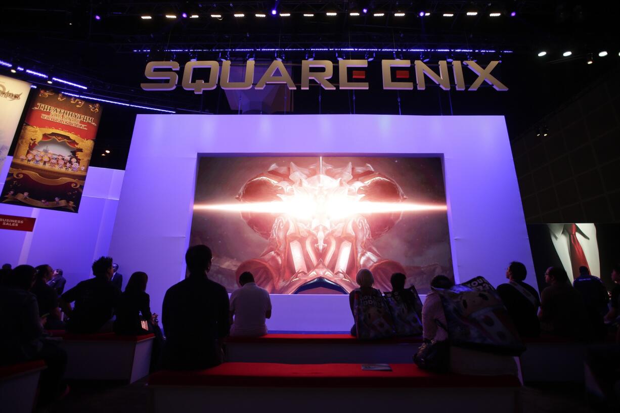 Associated Press files
People watch a video game trailer at the Square Enix booth at the Electronic Entertainment Expo in Los Angeles on June 10.  Bethesda and Square Enix are among the publishers promoting forthcoming titles by hosting their own flashy E3 briefings.