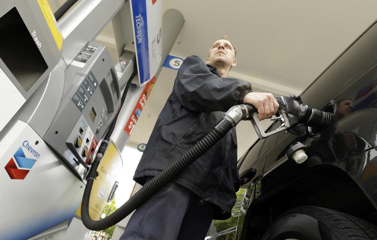 Attendant James Lewis pumps gas at a station in Portland.