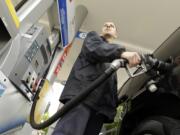 Attendant James Lewis pumps gas at a station in Portland.