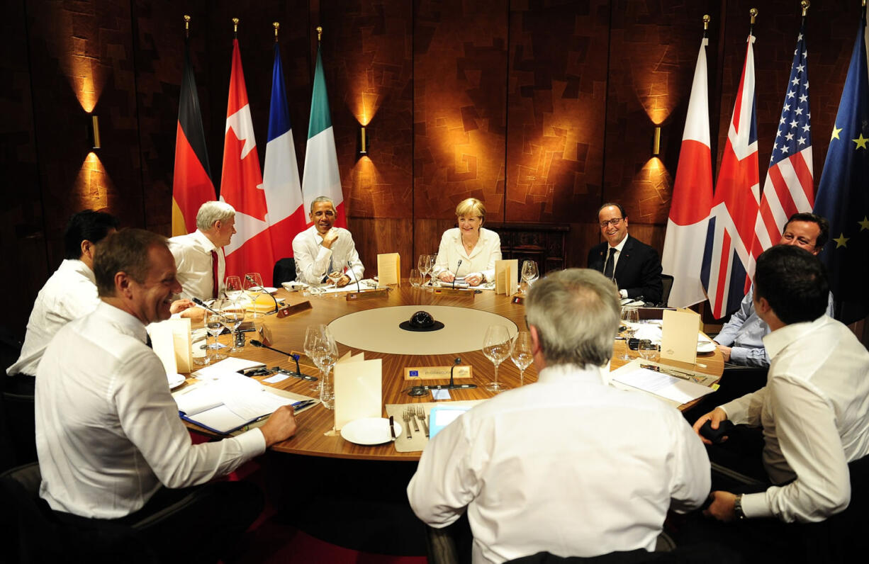 Japan's Shinzo Abe, clockwise from left, Canada's Stephen Harper, President Barack Obama, Germany's Angela Merkel, French President Fran?ois Hollande, Britain's David Cameron, Italy's Matteo Renzi, EU Commission President Jean-Claude Juncker and EU Council President Donald Tusk attend a working dinner Sunday at a G-7 summit near Garmisch-Partenkirchen, Germany.